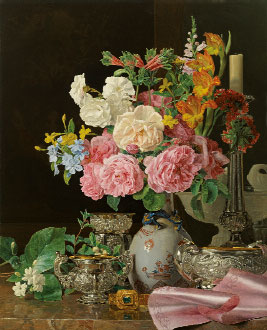 Flowers in a porcelain vase with candlestik and silver vessels